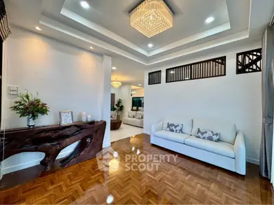 Elegant living room with modern chandelier and stylish wooden console table
