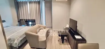 Modern studio apartment with cozy living area and stylish furnishings.