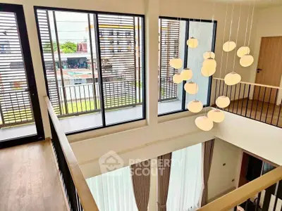 Stunning modern duplex with high ceilings and elegant lighting in a bright, airy space.