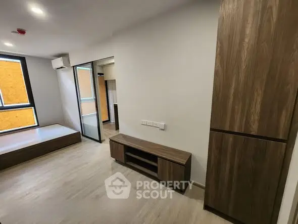 Modern minimalist bedroom with wooden furniture and large windows