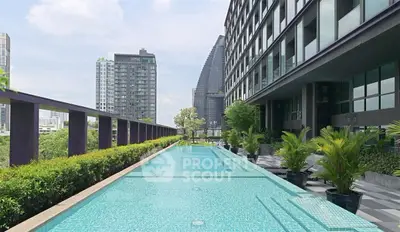 Luxurious rooftop pool with stunning cityscape views in modern high-rise building.