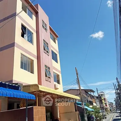 Charming multi-story building with vibrant facade in a bustling neighborhood, perfect for urban living.