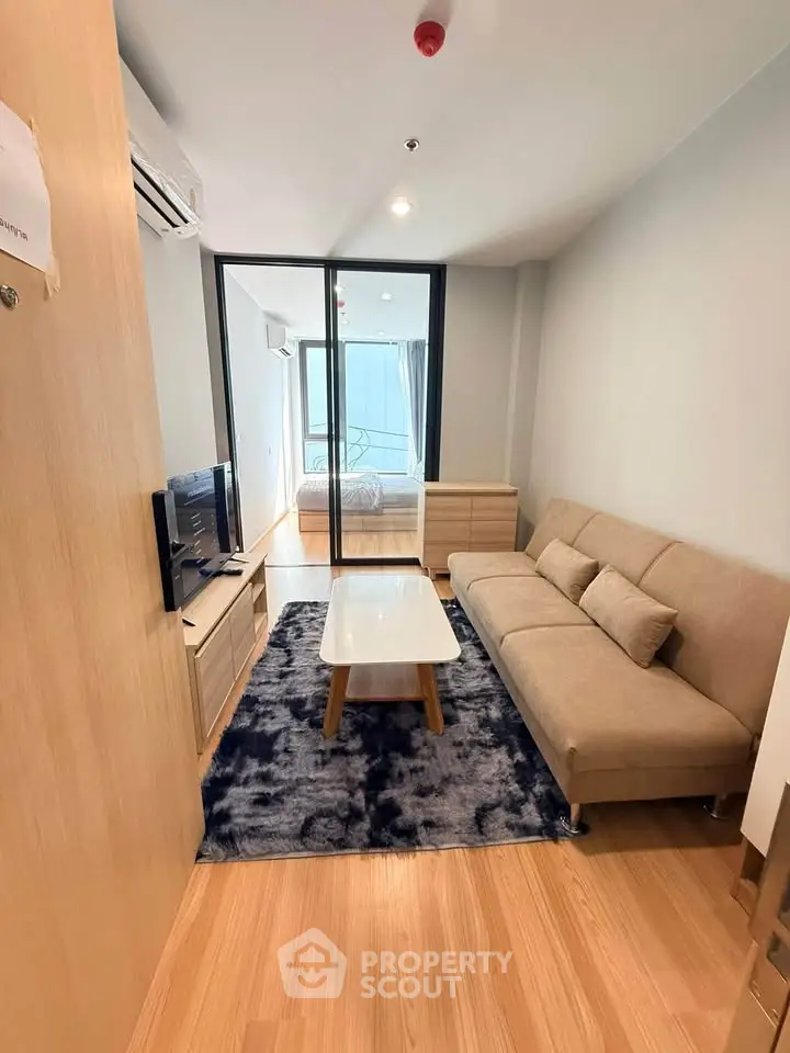 Modern living room with cozy sofa and stylish decor in a contemporary apartment.