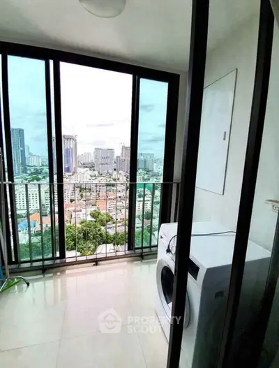 High-rise apartment balcony with city view and washing machine