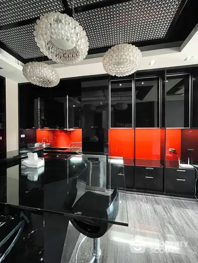 Luxurious modern kitchen with sleek black cabinets and striking red backsplash