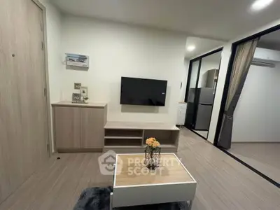 Modern living room with sleek design and open layout, featuring a wall-mounted TV and stylish furniture.