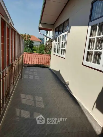 Spacious balcony with tiled flooring and scenic view, perfect for relaxation and outdoor enjoyment.