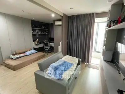 Spacious living room with modern decor and balcony access in a stylish apartment.