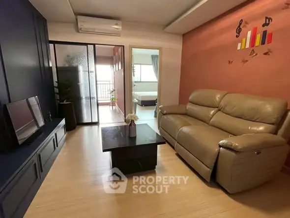 Modern living room with leather sofa and stylish decor in a cozy apartment.