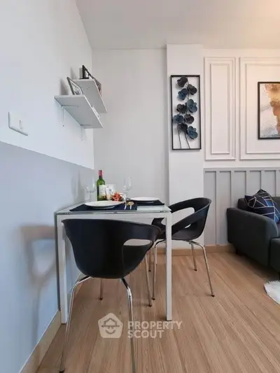 Modern dining area with stylish decor and wooden flooring in a cozy apartment.