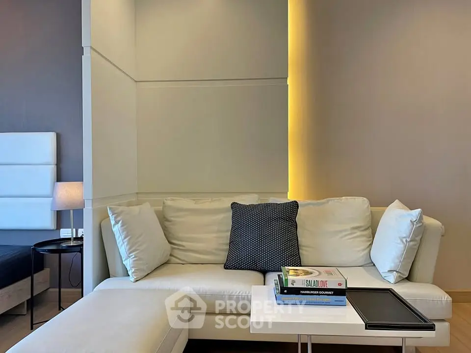 Modern living room with stylish sofa and accent lighting, perfect for relaxation and entertaining.