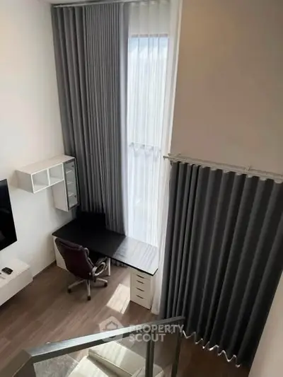 Modern study area with high ceilings and large windows in a stylish apartment.