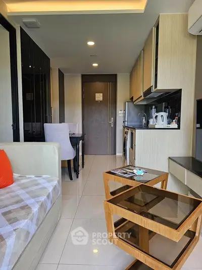 Modern living room with open kitchen layout and stylish furniture in a cozy apartment.