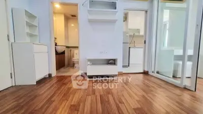 Modern apartment interior with wooden flooring and compact kitchen