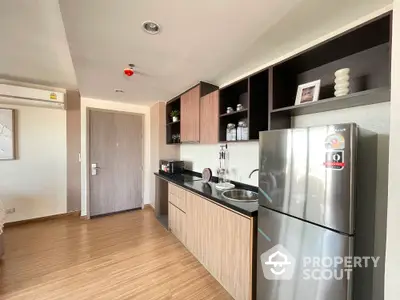 Modern kitchen with sleek cabinets and stainless steel fridge in stylish apartment