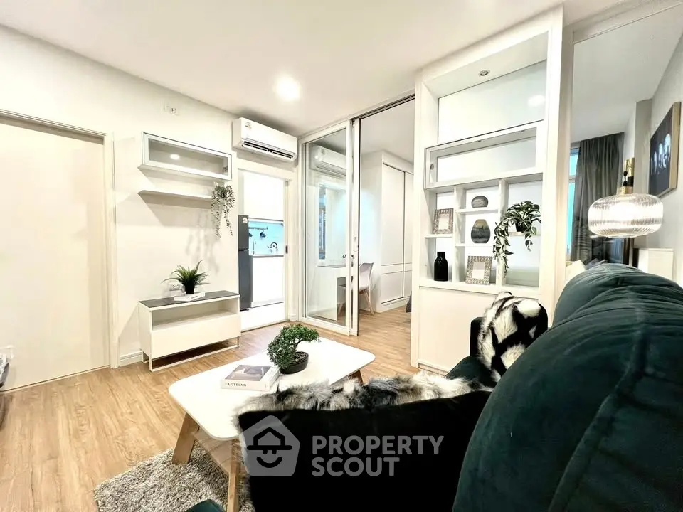 Modern living room with stylish decor and open layout, featuring cozy seating and elegant lighting.