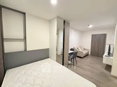 Modern studio apartment with open layout, featuring a cozy living area and stylish furnishings.