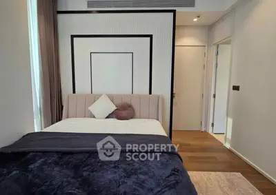 Modern bedroom with stylish decor and cozy bedding in a contemporary apartment.