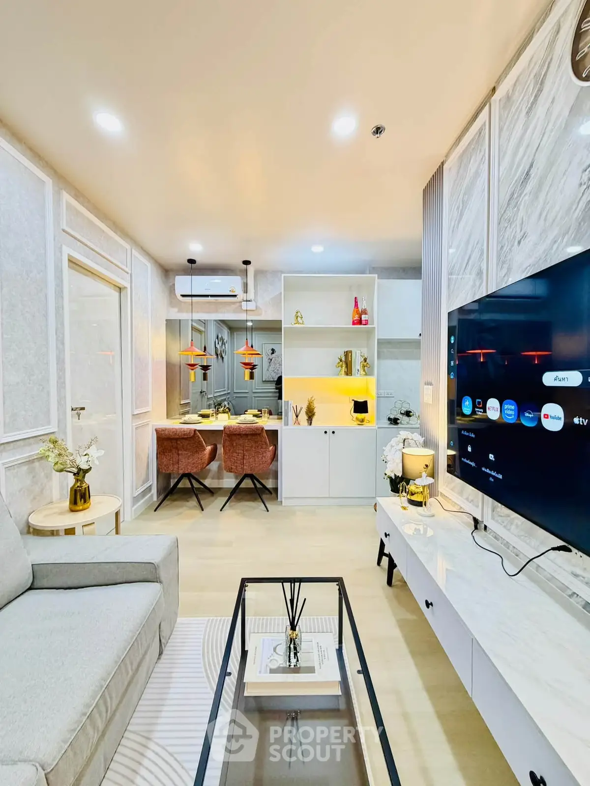 Modern living room with stylish decor and open layout, featuring a cozy seating area and sleek entertainment setup.