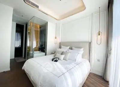 Luxurious bedroom with elegant decor and modern lighting in a high-end apartment.