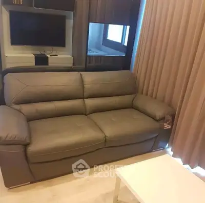 Modern living room with sleek leather sofa and wall-mounted TV, perfect for cozy relaxation.