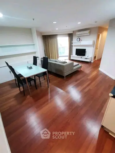 Spacious living room with wooden flooring and modern furniture