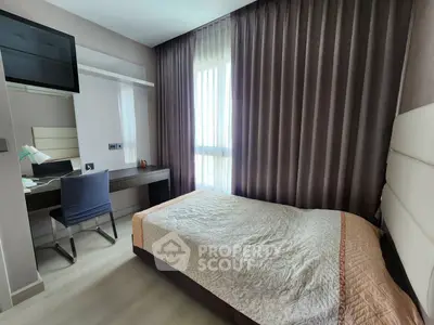 Modern bedroom with elegant decor and natural light, featuring a cozy bed and stylish workspace.