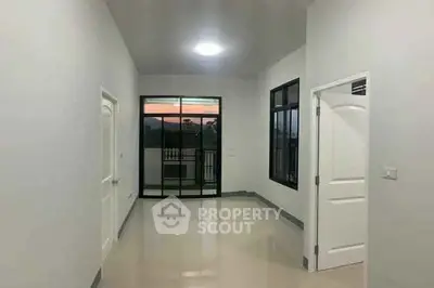 Spacious empty room with large windows and balcony access, perfect for customization.