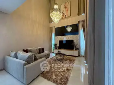 Luxurious living room with high ceilings, elegant chandeliers, and plush furnishings for a sophisticated ambiance.