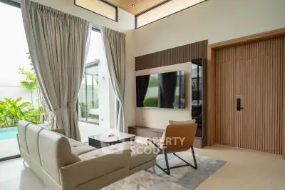 Luxurious living room with modern decor and pool view, featuring elegant furniture and large windows.