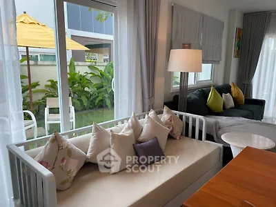 Charming living room with cozy seating and garden view, perfect for relaxation and entertaining.