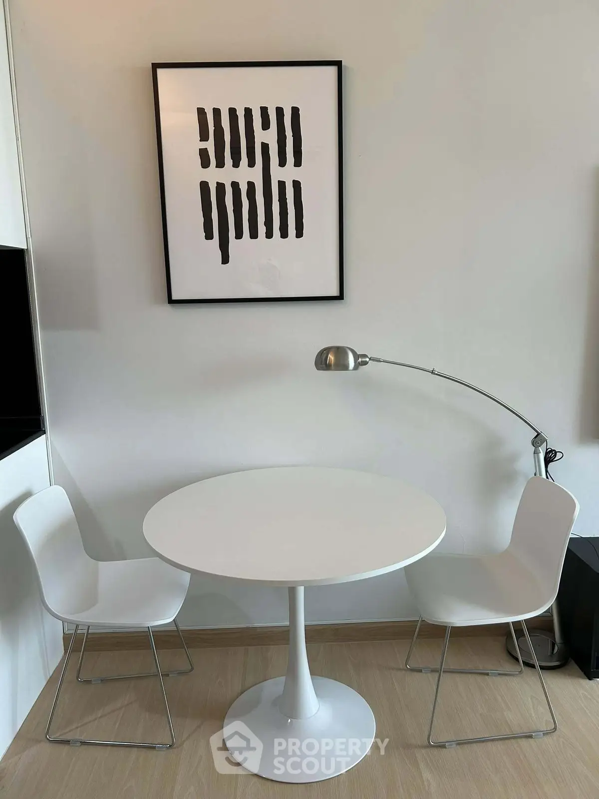 Modern minimalist dining nook with round table and stylish chairs