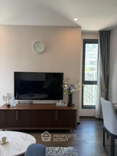 Modern living room with sleek TV unit and large window view