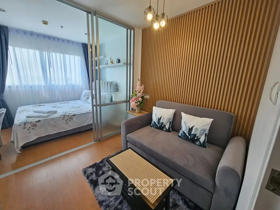 Modern studio apartment with cozy living area and stylish bedroom divider