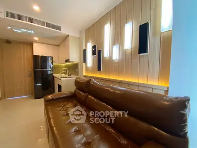 Modern living room with leather sofa and stylish lighting in a contemporary apartment.