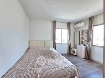 Spacious bedroom with modern decor and natural light