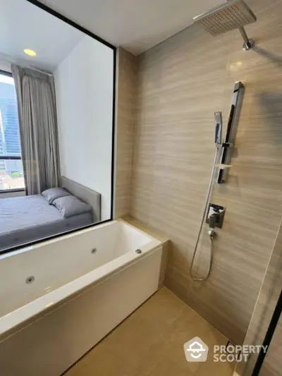 Modern bathroom with bathtub and shower, adjacent to bedroom with city view.