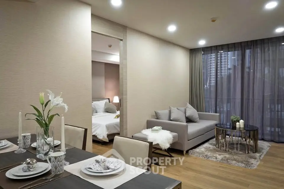 Modern open-plan living and dining area with elegant decor and cozy ambiance.
