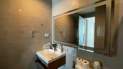 Modern bathroom with sleek sink and large mirror