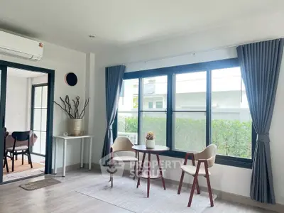 Bright living room with large windows and modern decor