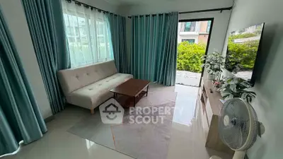 Charming living room with modern decor, large windows, and garden view, perfect for relaxation and entertaining.