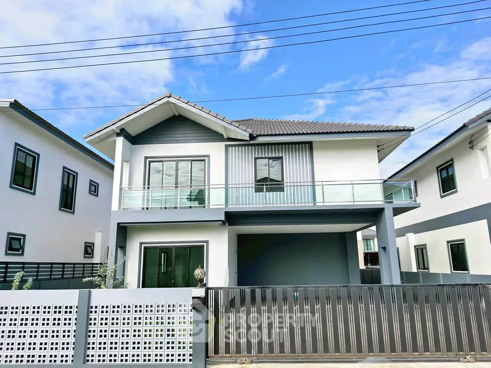 Modern two-story house with sleek design and spacious balcony in a serene neighborhood.