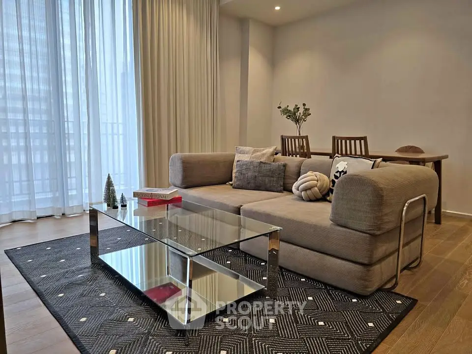 Modern living room with stylish sofa and glass coffee table, perfect for urban living.