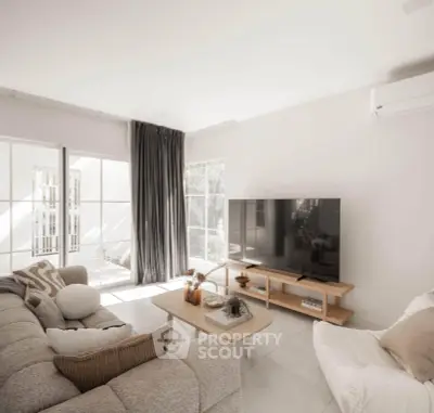 Spacious modern living room with large windows and cozy seating area