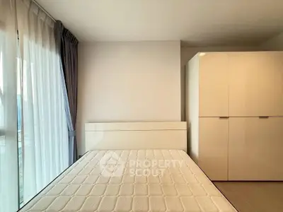 Spacious bedroom with large window and modern wardrobe, perfect for natural light lovers.