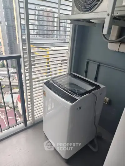 Modern balcony with washing machine and city view, perfect for urban living convenience.
