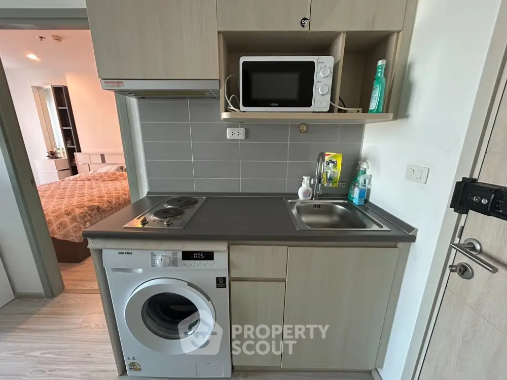 Compact kitchen with modern appliances in cozy apartment