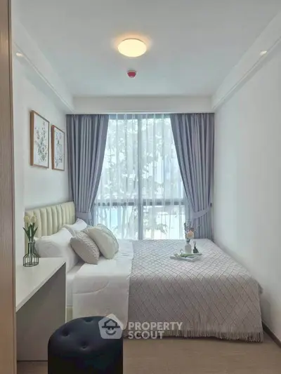 Cozy bedroom with elegant decor and large window view