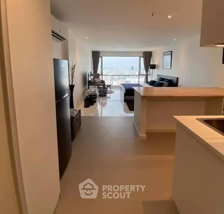 Spacious open-plan living room with city view, modern kitchen, and elegant decor.