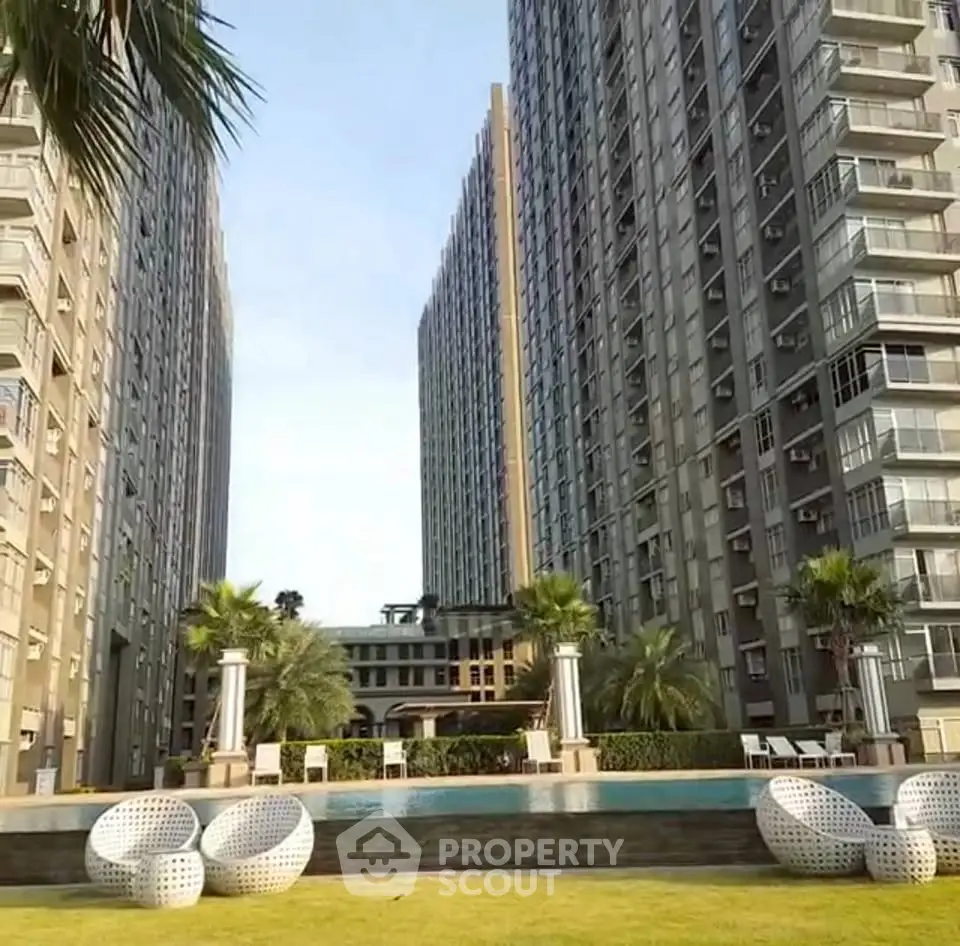 Luxurious high-rise apartment complex with pool and garden view